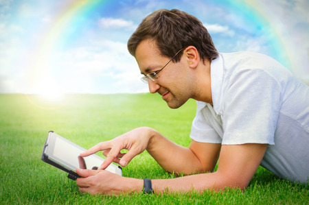 Adult man working with tablet computer outdoor in parkの写真素材