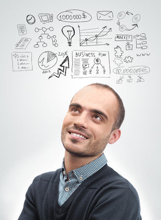 Young business man looking up and planning  Graphic sketch style thoughts overheadの写真素材
