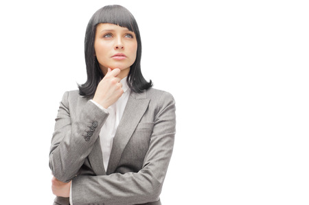 Caucasian business woman thinking in looking pensive and happy in formal clothes isolated on white background の写真素材