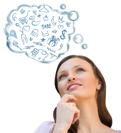 Beautiful young woman daydreaming over white background with finger on chinの写真素材