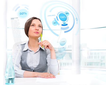 Businesswoman working with high tech type of modern interface at her modern officeの写真素材