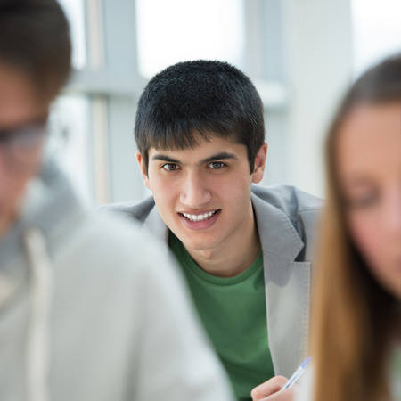Group of students studying together in classroomの写真素材