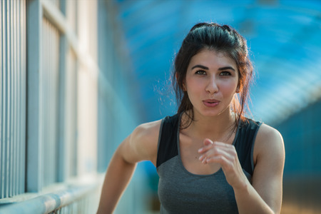Healthy lifestyle beautiful woman running at the city urban backgroundの写真素材