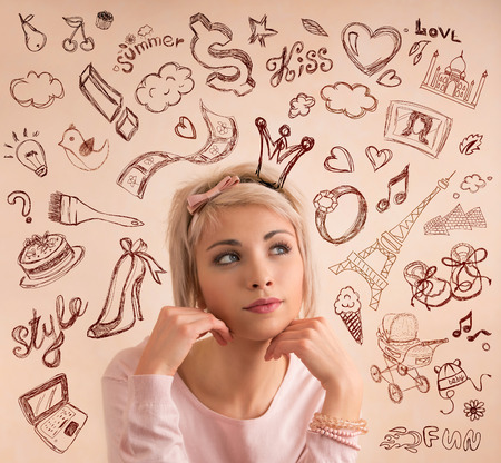 Young woman thinking of her wishesの写真素材
