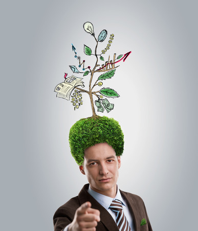 Man with green tree growing instead of hair. Environment friendly business conceptの写真素材