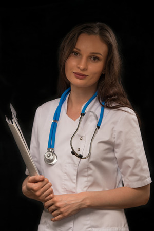 Female doctor reading medical recordの写真素材