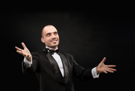 Champion business man standing with hands opened in victoryの写真素材