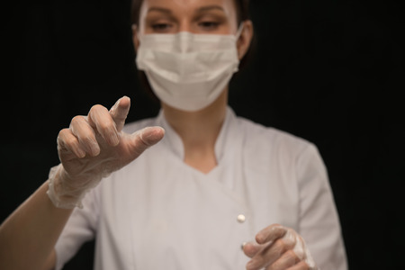 Doctor wearing mask working with virtual screen. Distant surgery conceptの写真素材