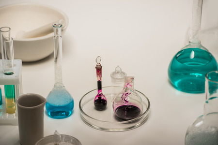 Group of laboratory flasks liquid on table