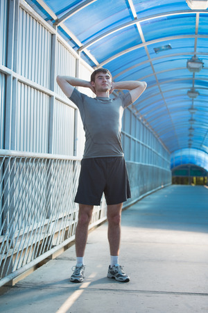 Man stretching outdoors in cityの写真素材