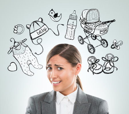 Young business woman thinking of her pregnancy plans closeup face portrait and sketches overheadの写真素材