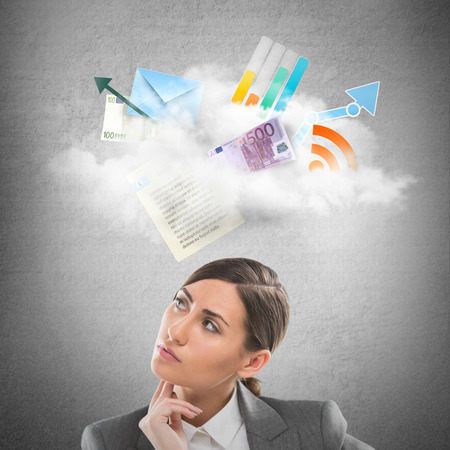 Businesswoman looking using cloud technologies to store her data and be free and mobileの写真素材