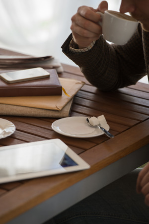 Young businessman on a coffee break. Using tablet computer.の写真素材