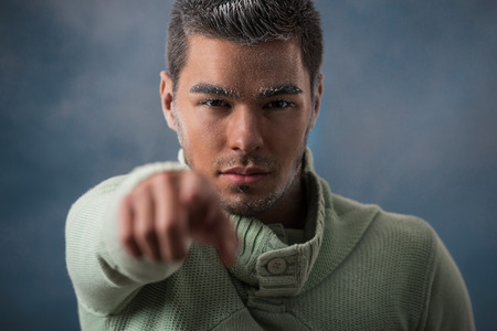 Man warming up with casual pullover in wintertime. Frost makeup. Dark smoky backgroundの写真素材