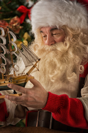 Santa Claus in his workshop making new toys for Christmas Presents for children around the worldの写真素材