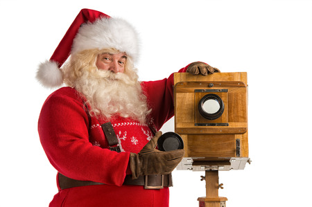 Santa Claus taking picture with old wooden cameraの写真素材