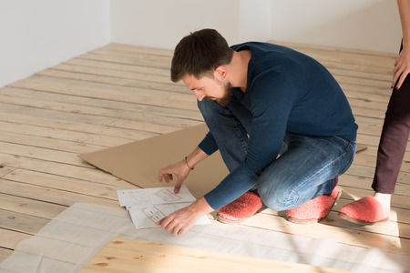 Man Putting Together Self Assembly Furniture In New Homeの写真素材