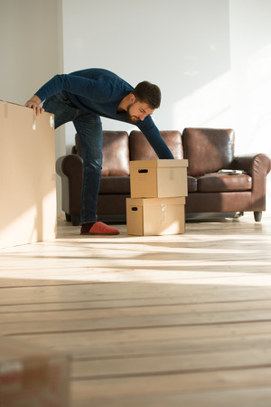 Man carrying stacked boxes on moving dayの写真素材