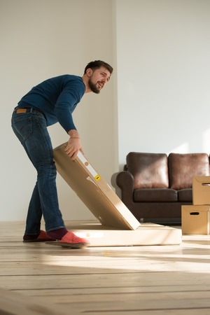 Man carrying stacked boxes on moving dayの写真素材