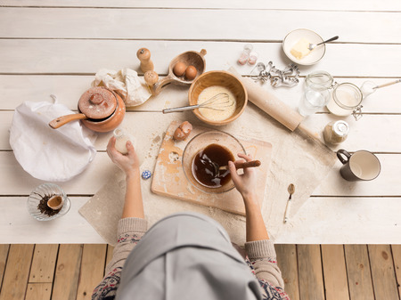 Woman baking Christmas cookies in her kitchen. Top viewの写真素材