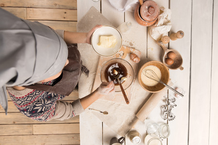 Woman baking Christmas cookies in her kitchen. Top viewの写真素材