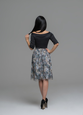 Full Length Portrait of a Sexy Brunette Woman in Fashion Dress back viewの写真素材