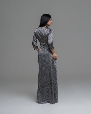 Full Length Portrait of a Sexy Brunette Woman in Fashion Dress back viewの写真素材