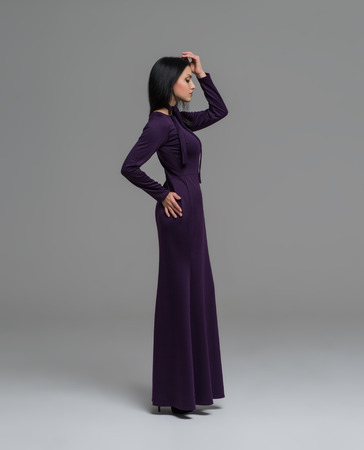 Elegant brunette in sexy dress posing in the studioの写真素材