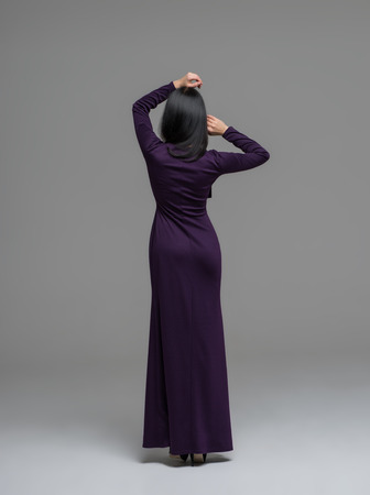 Full Length Portrait of a Sexy Brunette Woman in Fashion Dress back viewの写真素材