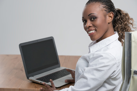 Rear view of african woman working on her laptopの写真素材