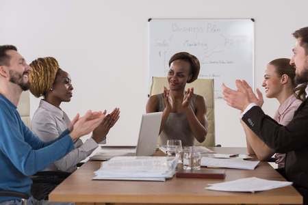 Photo of happy business people applauding at meeting focus on boss african girlの写真素材