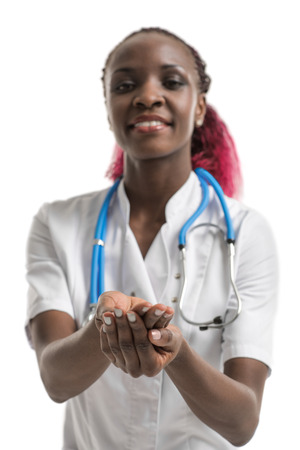 Female african doctor holding and sharing something in her handの写真素材