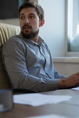 Handsome businessman working in officeの写真素材