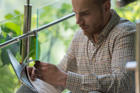 Portrait of a businessman received envelope reading documentsの写真素材