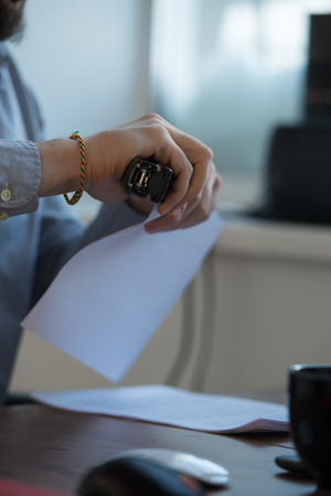 Handsome businessman signing contract in officeの写真素材