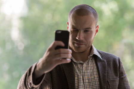 Businessman taking a selfie on smartphoneの写真素材