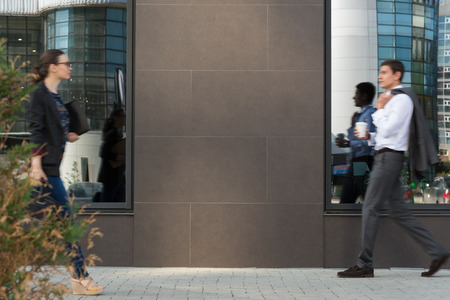 Two businesspeople walking on the street near office building