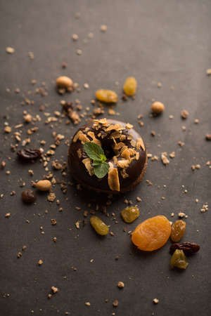 Chocolate Donut with mint leaf on dark stone backgroundの写真素材