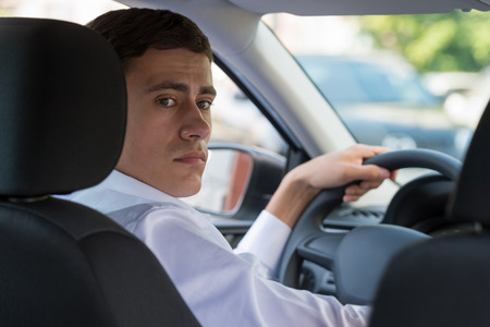 The young man behind the wheel driving car