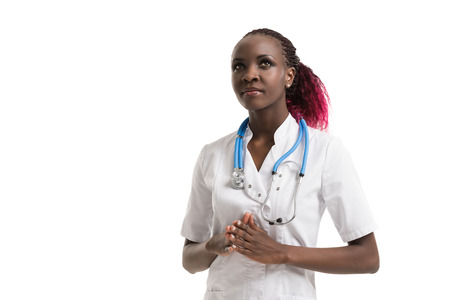 Closeup portrait, young female doctor, health care professional, daydreaming, thinking, looking up at copy space isolated white background. Patient visit health care reform. Human emotion, expressionの写真素材
