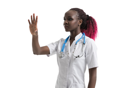 Female african doctor with stethoscope working with virtual screenの写真素材