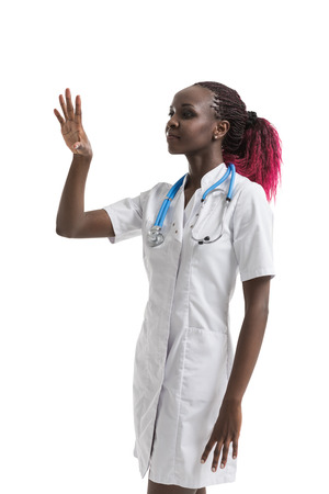 Female african doctor with stethoscope working with virtual screenの写真素材