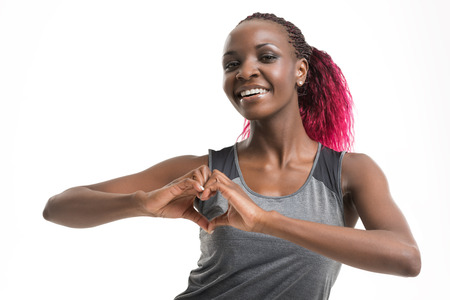 Portrait of a young cheerful african sport woman isolated on white backgroundの写真素材