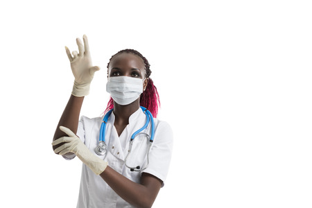 Female african doctor with stethoscope working with virtual screenの写真素材