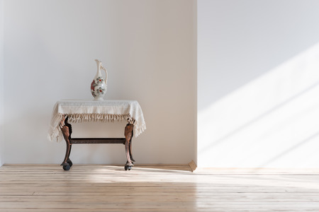 Vintage table and vase in sunlightの写真素材