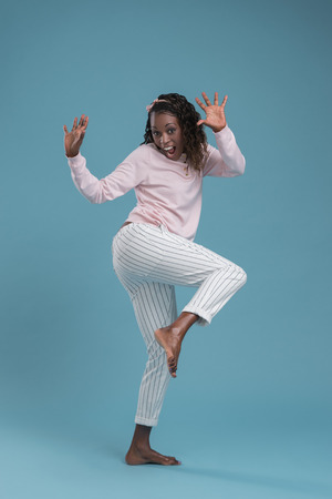 Portrait of cute african woman posing - dancing full lengthの写真素材