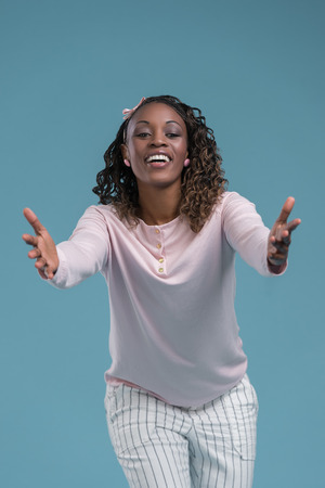 Portrait of cute african woman posing - welcoming gestureの写真素材