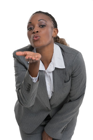 Business woman sending airkiss to camera, isolated on white backgroundの写真素材