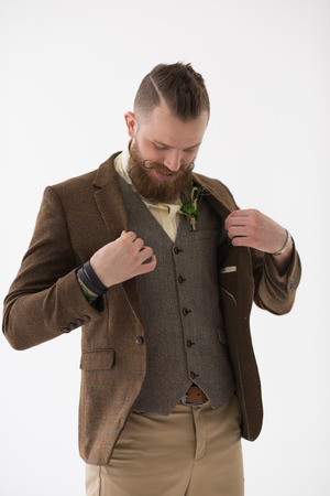 Closeup portrait of modern groom putting on clothes and accessories before his weddingの写真素材