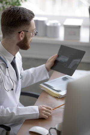 Doctor examining an elbow x-ray. Medicine and healthcareの写真素材